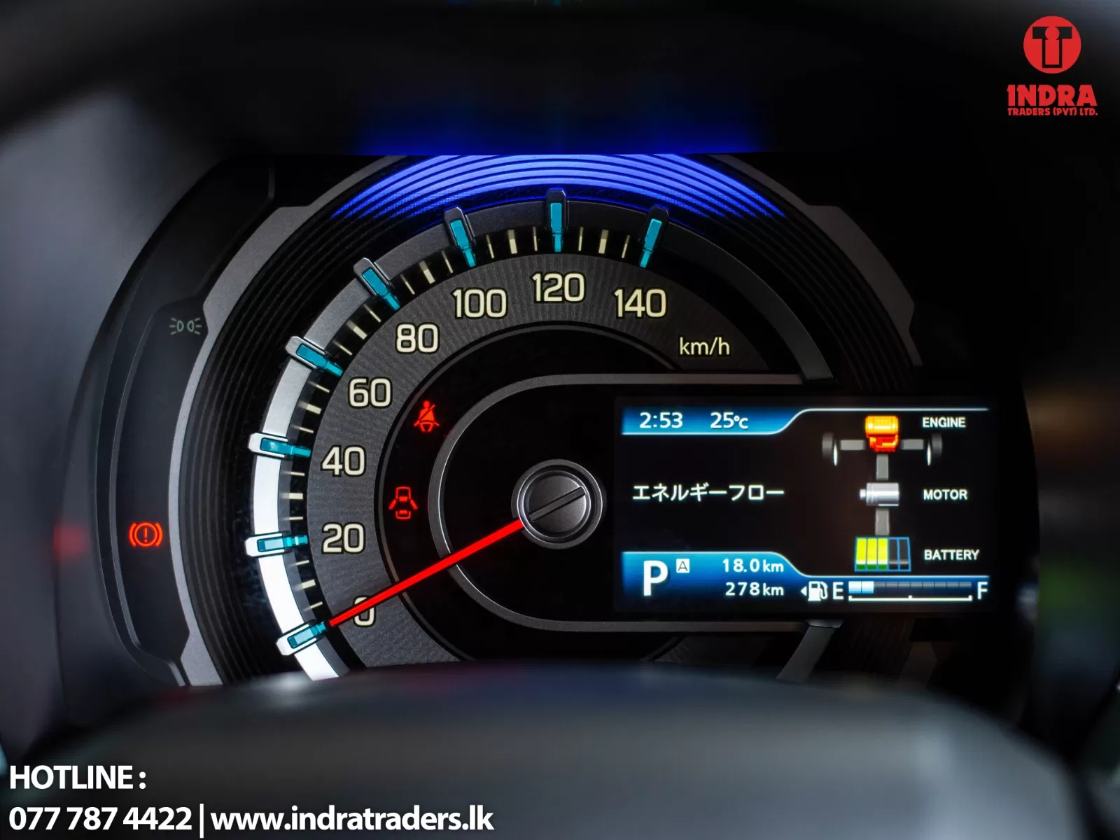 Close-up of a car's instrument cluster: speedometer up to 140 km/h with blue accents and a right-side digital display showing status icons; hotline text in the corner.