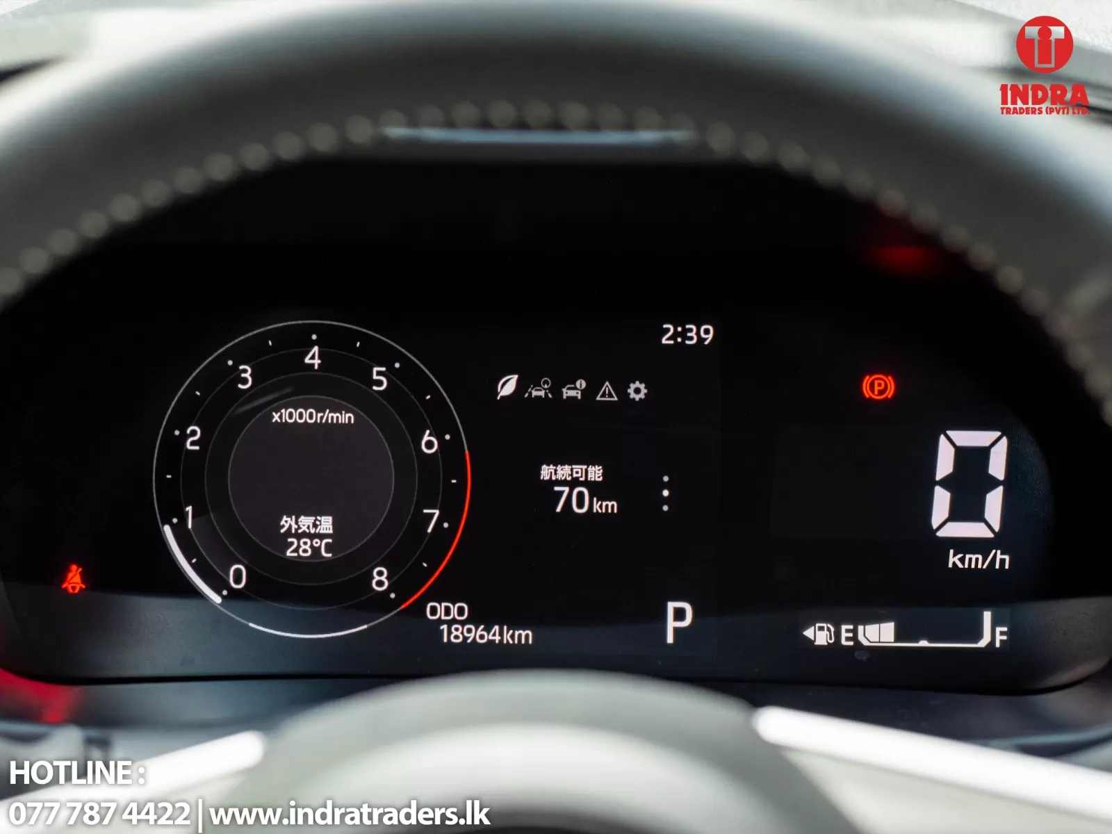 Digital car instrument cluster showing tachometer, time 2:39, outside temp 28°C, odometer 18,964 km, gear in P, parking brake indicator, and 0 km/h speed.