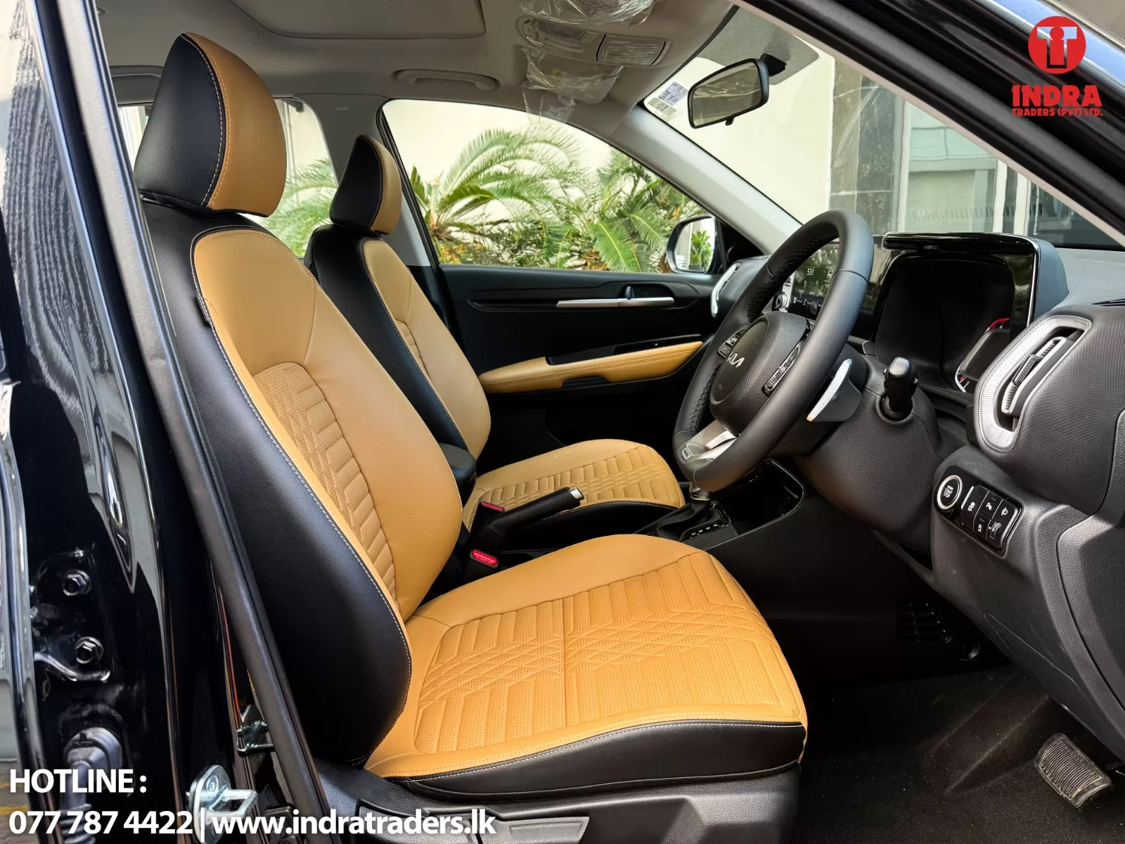 Interior of a modern SUV with tan leather seats and black accents; steering wheel and digital dashboard visible at the front.