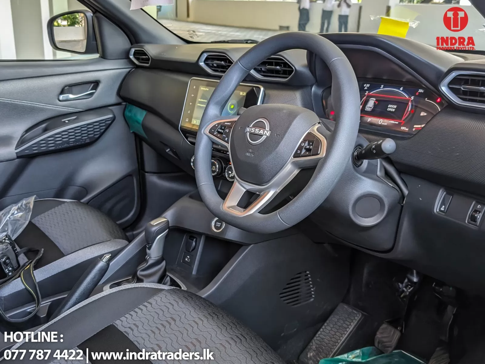 Interior of a Nissan car focusing on the steering wheel and dashboard with a central touchscreen display](https://example.com)