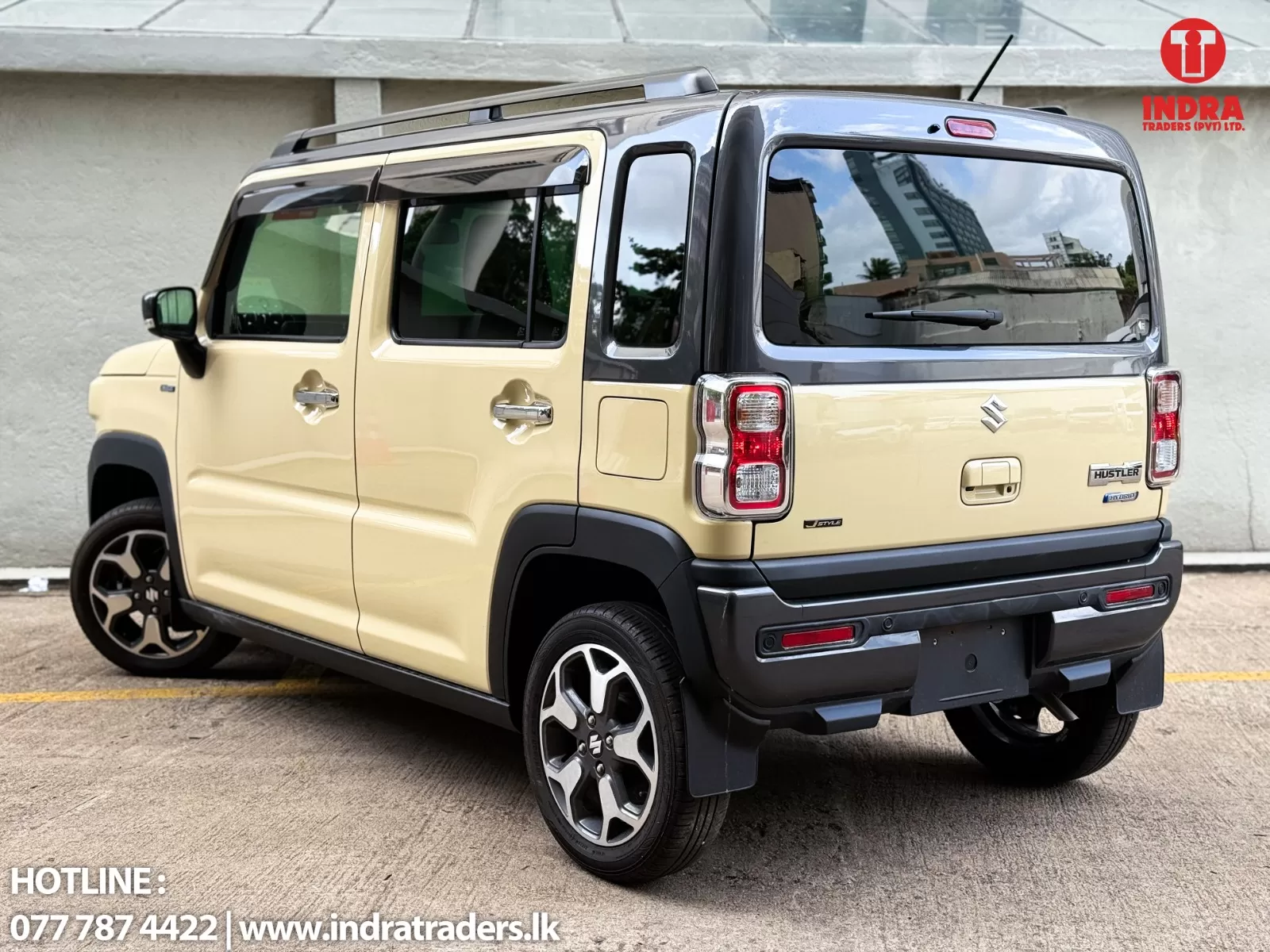 Beige Suzuki Hustler with black roof rails, shown from rear-passenger side in a dealership lot; Indra Traders logo top-right.