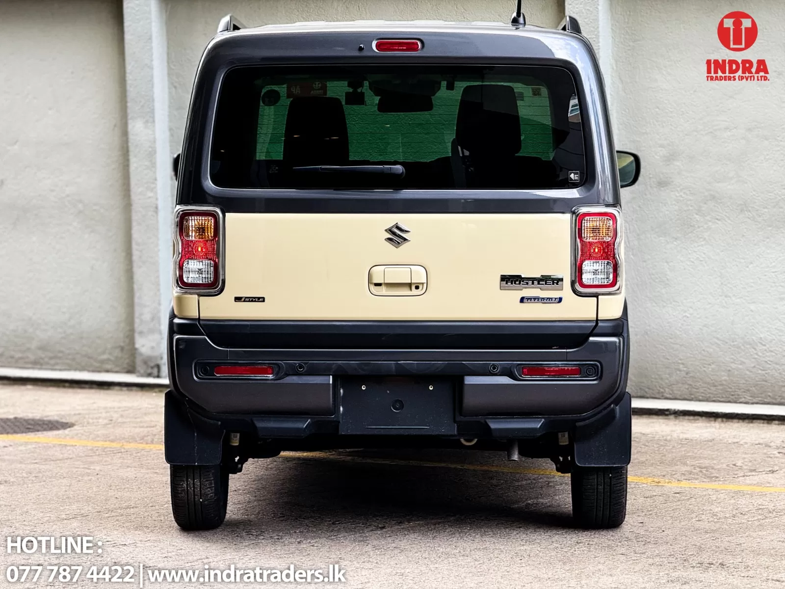 Rear view of a Suzuki Hustler Hybrid SUV with beige rear panel and black bumper; dealership watermark in top-right reads INDRA TRADERS (PVT) LTD.