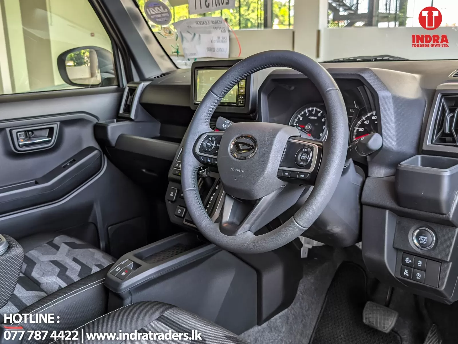 Front interior of a modern car showing the steering wheel, instrument cluster, and center touchscreen display.