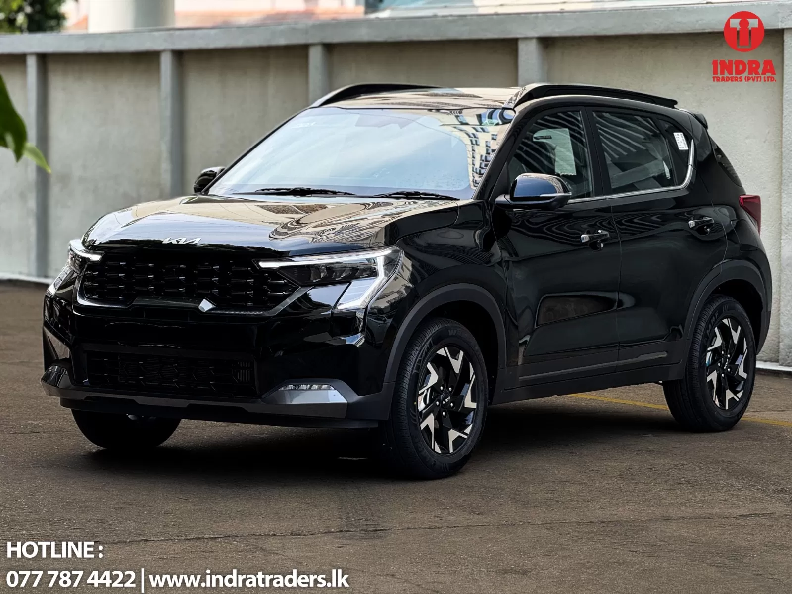 Black compact SUV parked outdoors, front three-quarter view; Indra Traders watermark in the top-right corner.
