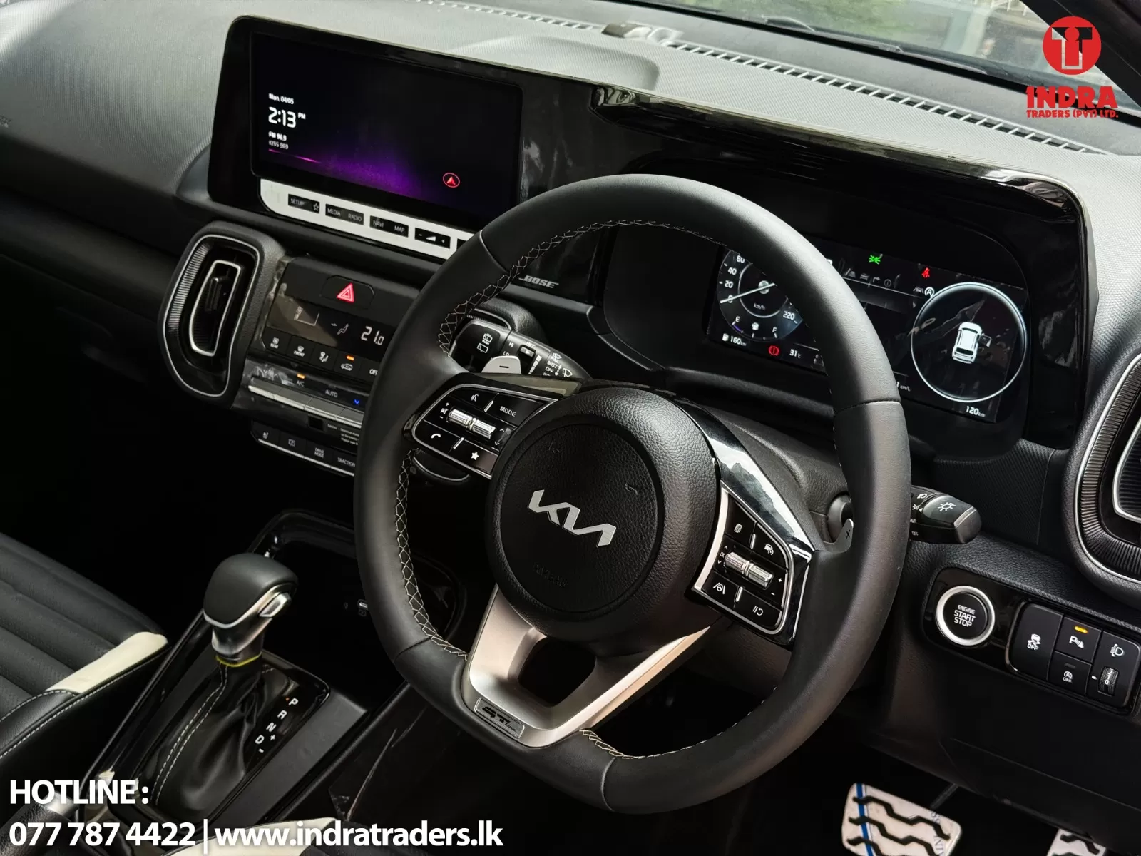 Interior of a modern black SUV showing a digital instrument cluster, large touchscreen infotainment, climate control panel, and a leather-wrapped steering wheel with multi-function controls.