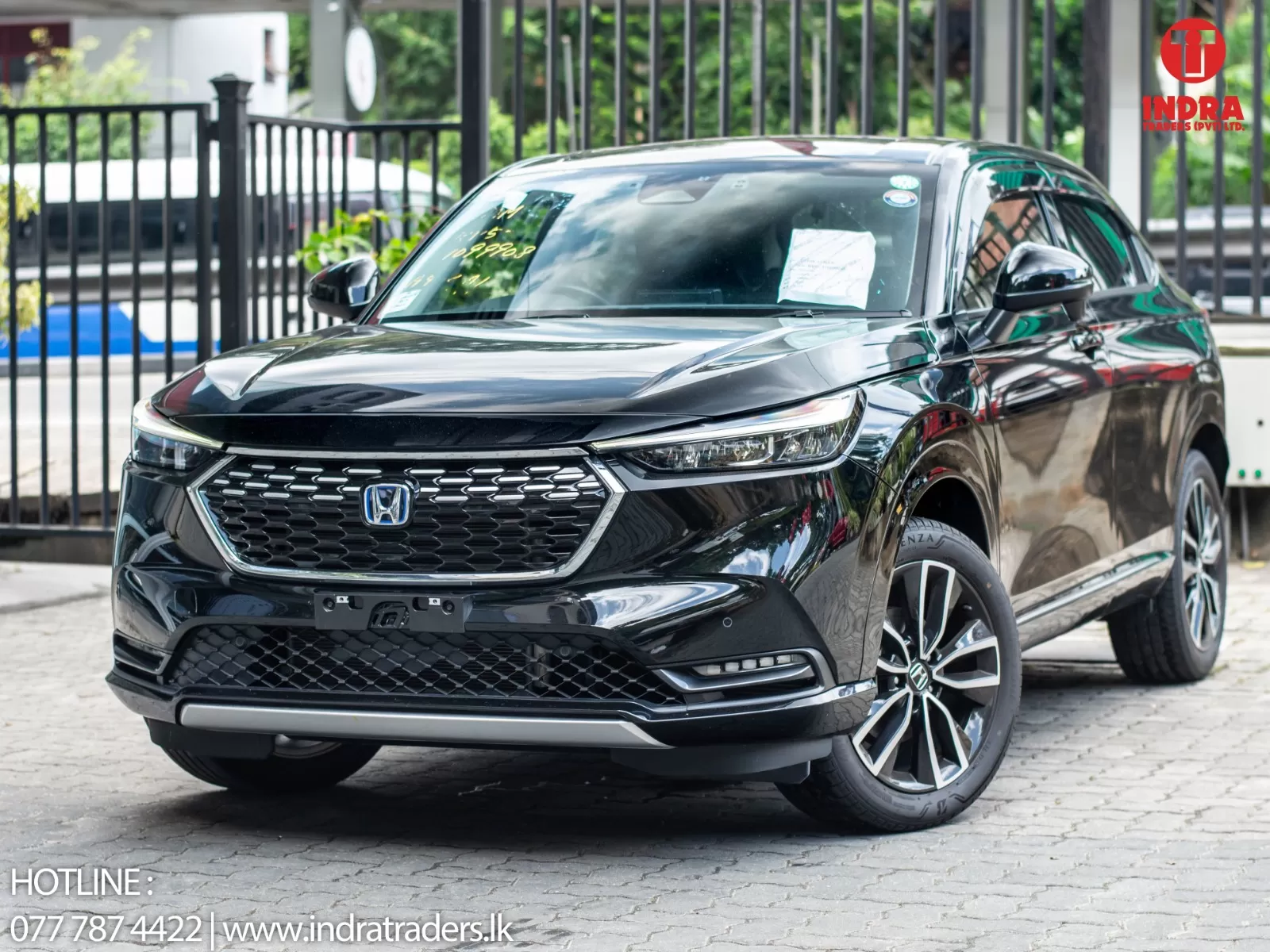 Black Honda SUV parked on a paved lot, front view showing grille and alloy wheels.