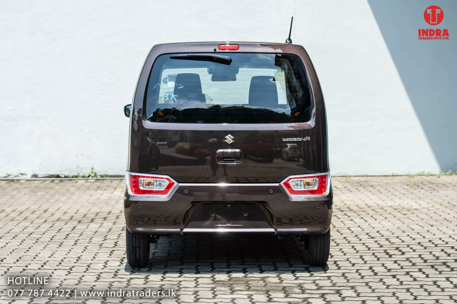 Rear view of a brown Suzuki Wagon R on a brick parking lot, with the Indra Traders logo in the top-right corner.